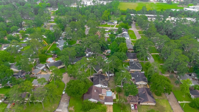 aerial view of property and surrounding area featuring nearby suburban area