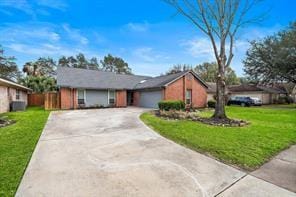 15418 Windy Cove Dr, Houston, TX 77095 - ranch-style house featuring driveway, a front yard, and an attached garage