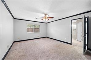 15418 Windy Cove Dr, Houston, TX 77095 - spare room with ornamental molding, carpet flooring, baseboards, and ceiling fan