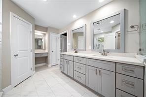 15418 Windy Cove Dr, Houston, TX 77095 - full bathroom with recessed lighting, a shower with shower door, double vanity, baseboards, and tile patterned floors
