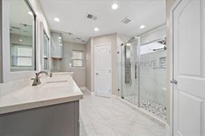 15418 Windy Cove Dr, Houston, TX 77095 - bathroom featuring a stall shower, recessed lighting, vanity, baseboards, and plenty of natural light