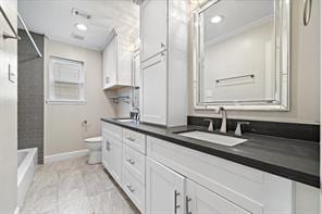 15418 Windy Cove Dr, Houston, TX 77095 - bathroom featuring toilet, double vanity, and baseboards
