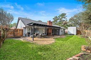 15418 Windy Cove Dr, Houston, TX 77095 - rear view of house with a patio and a chimney
