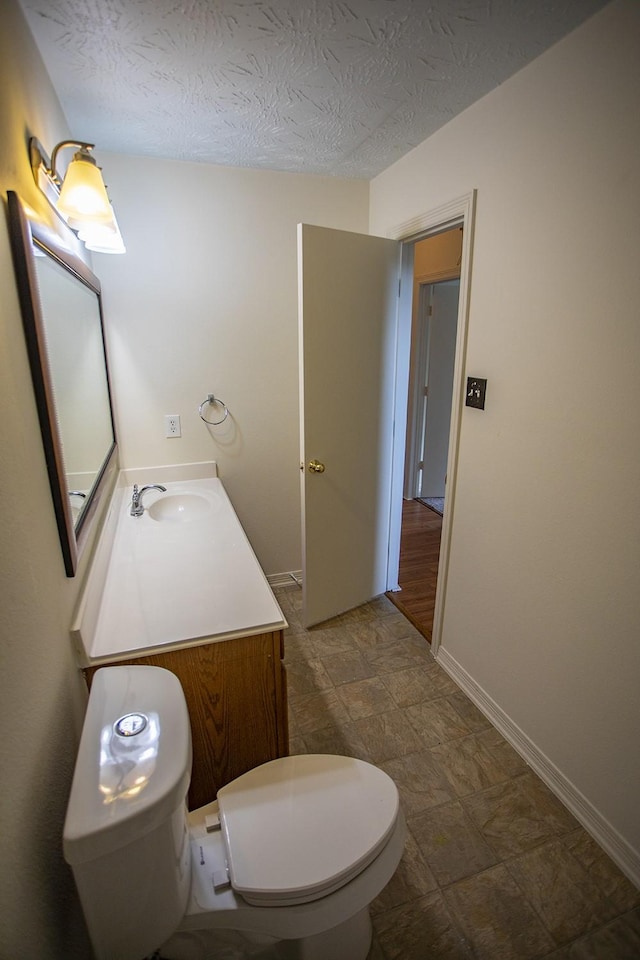 21926 Crestworth Ln, Katy, TX 77449 - bathroom featuring toilet, vanity, baseboards, and a textured ceiling