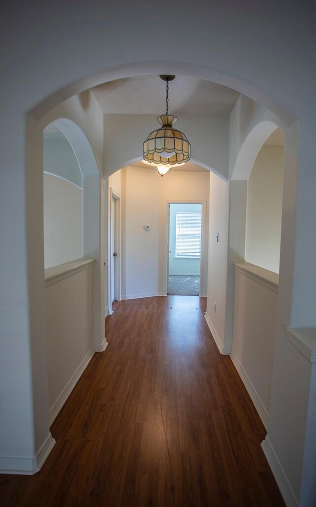 21926 Crestworth Ln, Katy, TX 77449 - hallway featuring wood finished floors, baseboards, and arched walkways