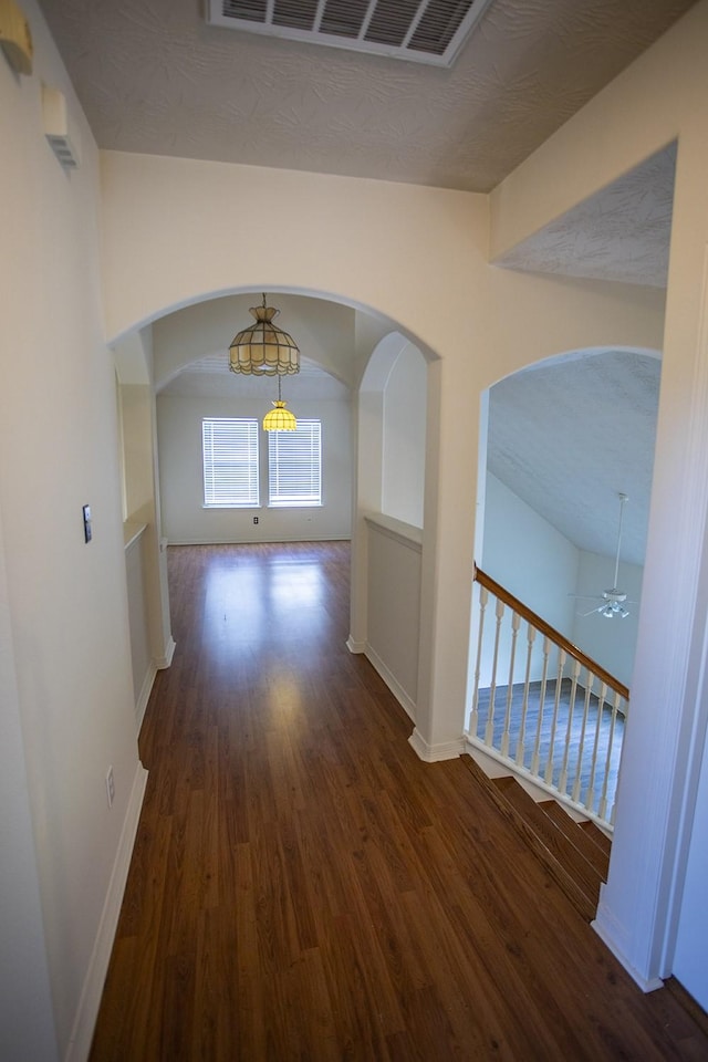 21926 Crestworth Ln, Katy, TX 77449 - hall featuring arched walkways, wood finished floors, and baseboards