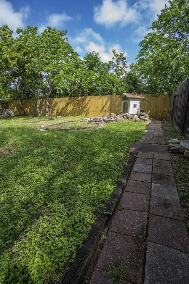 21926 Crestworth Ln, Katy, TX 77449 - view of yard with a storage unit and an outdoor structure