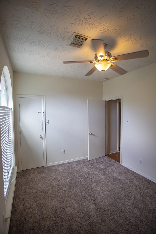21926 Crestworth Ln, Katy, TX 77449 - carpeted empty room with ceiling fan, baseboards, and a textured ceiling