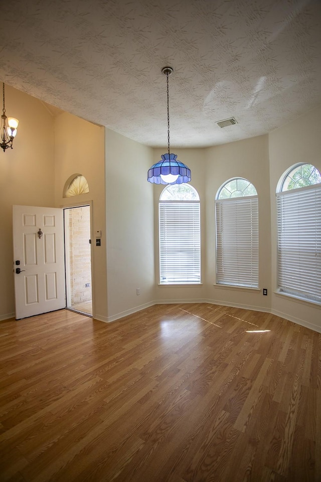 21926 Crestworth Ln, Katy, TX 77449 - unfurnished dining area featuring wood finished floors, a chandelier, and baseboards