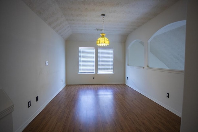 21926 Crestworth Ln, Katy, TX 77449 - unfurnished dining area with lofted ceiling, wood finished floors, baseboards, and a textured ceiling