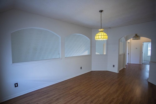 21926 Crestworth Ln, Katy, TX 77449 - empty room featuring wood finished floors, arched walkways, and baseboards