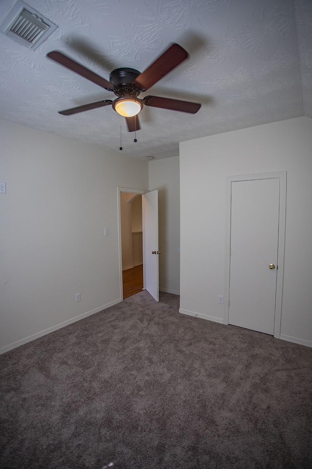 21926 Crestworth Ln, Katy, TX 77449 - unfurnished bedroom with carpet, baseboards, a ceiling fan, and a textured ceiling