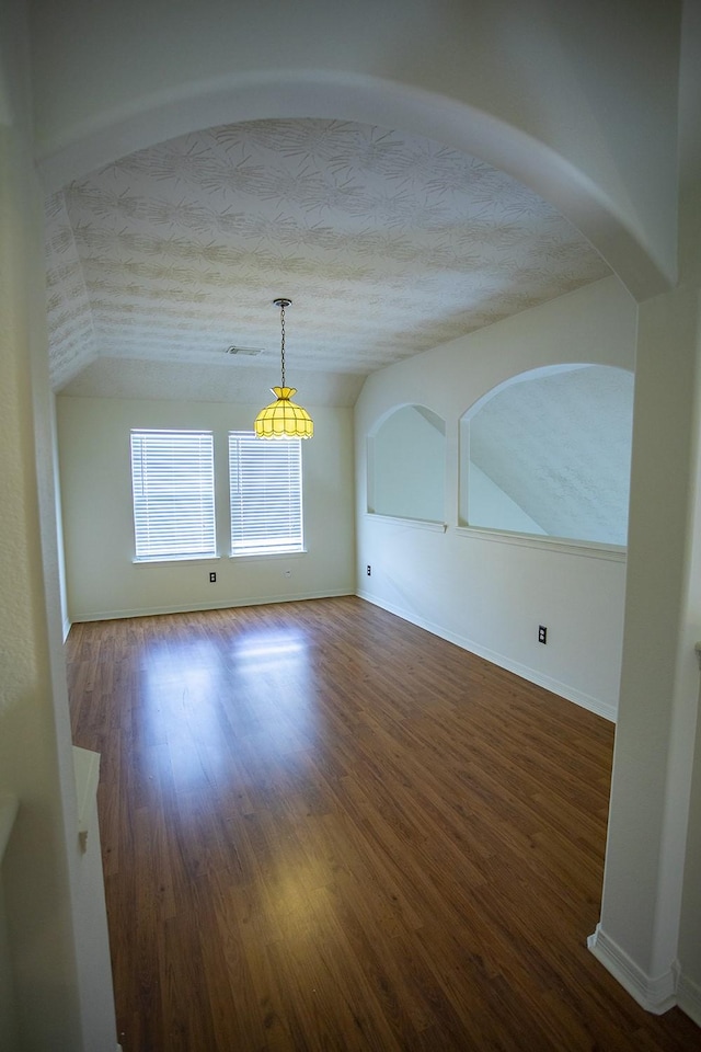 21926 Crestworth Ln, Katy, TX 77449 - unfurnished dining area featuring vaulted ceiling, wood finished floors, baseboards, and a textured ceiling
