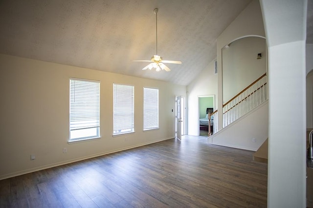 21926 Crestworth Ln, Katy, TX 77449 - unfurnished living room with a ceiling fan, wood finished floors, high vaulted ceiling, stairs, and arched walkways
