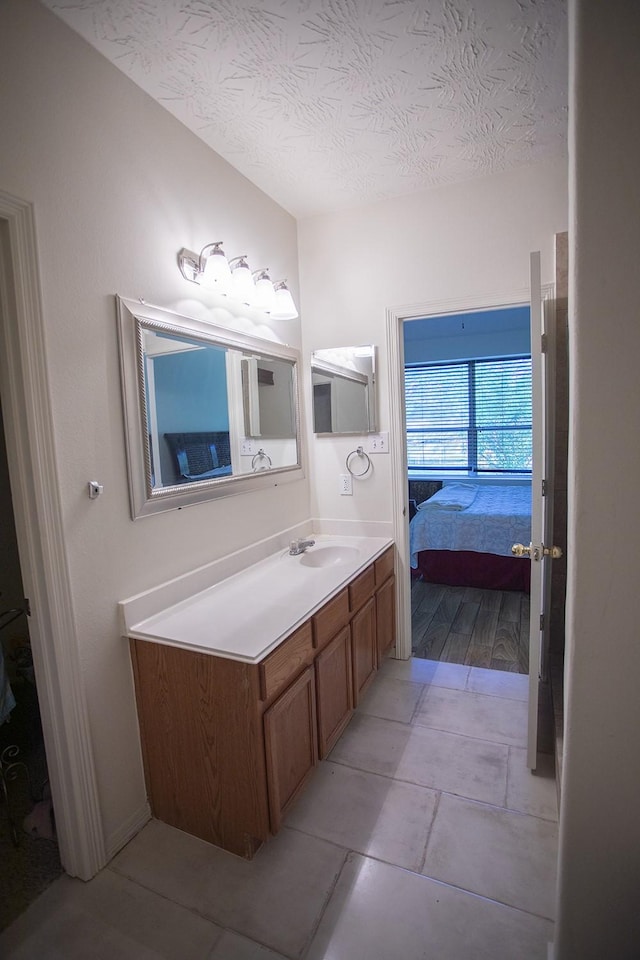 21926 Crestworth Ln, Katy, TX 77449 - bathroom with ensuite bath, vanity, and a textured ceiling