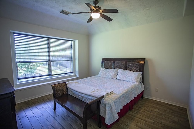 21926 Crestworth Ln, Katy, TX 77449 - bedroom with wood finished floors, baseboards, a textured ceiling, and ceiling fan