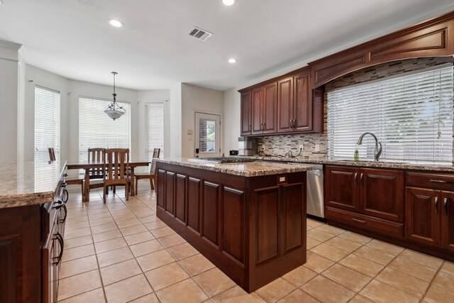 kitchen with a sink, a kitchen island, light tile patterned floors, decorative backsplash, and recessed lighting