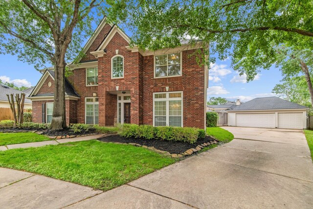 view of front of property featuring a detached garage and brick siding