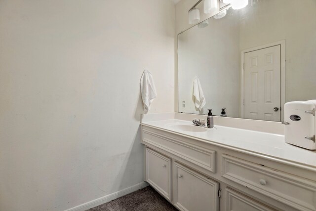 bathroom with vanity and baseboards