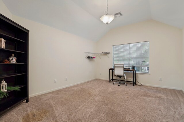 carpeted office space featuring vaulted ceiling and baseboards