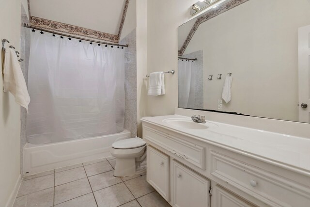 bathroom with toilet, tile patterned flooring, shower / bath combination with curtain, and vanity