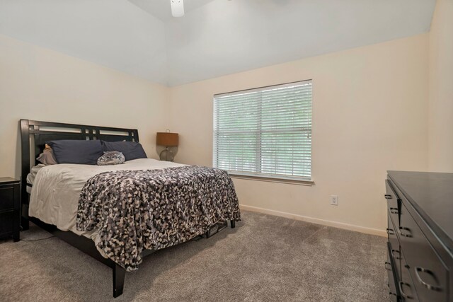 bedroom with carpet flooring, baseboards, ceiling fan, and lofted ceiling