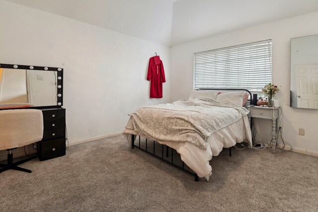 bedroom featuring carpet flooring, lofted ceiling, and baseboards