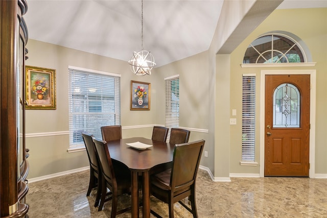 dining space featuring a chandelier and baseboards