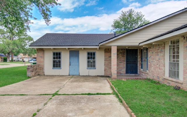 9502 Kell Cir, Houston, TX 77040 - doorway to property with a yard, brick siding, roof with shingles, and a patio