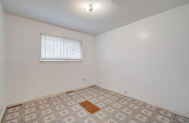 9502 Kell Cir, Houston, TX 77040 - empty room with baseboards, light flooring, and a textured ceiling
