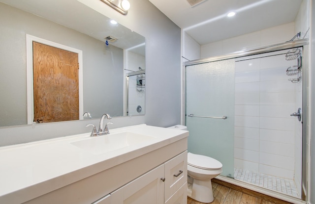 9502 Kell Cir, Houston, TX 77040 - full bathroom featuring toilet, a stall shower, wood finished floors, vanity, and recessed lighting