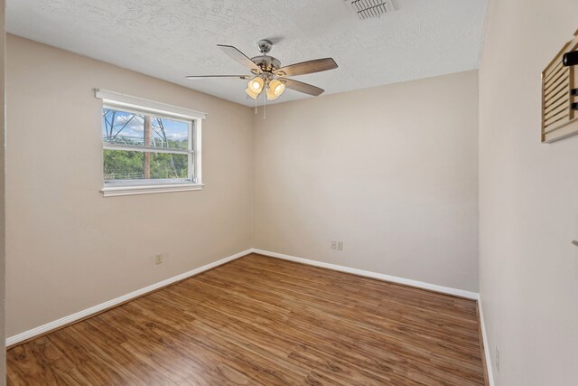 11802 Hamblin Rd, Cypress, TX 77429 - unfurnished room with ceiling fan, a textured ceiling, wood finished floors, and baseboards