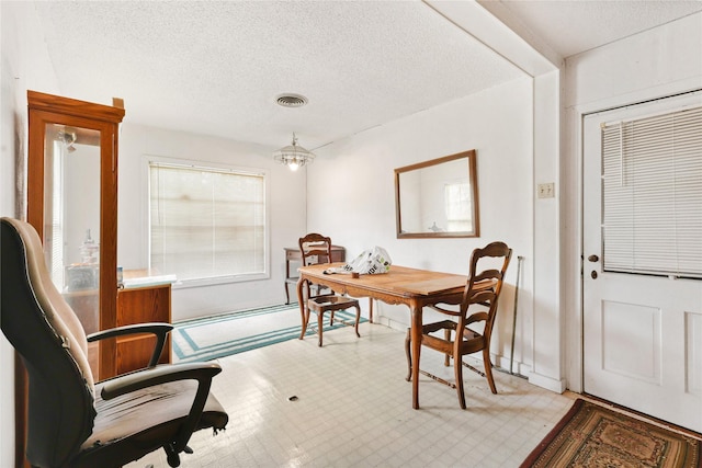 2316 Cleveland Ave, Waco, TX 76706 - dining room with a textured ceiling, a chandelier, and light floors