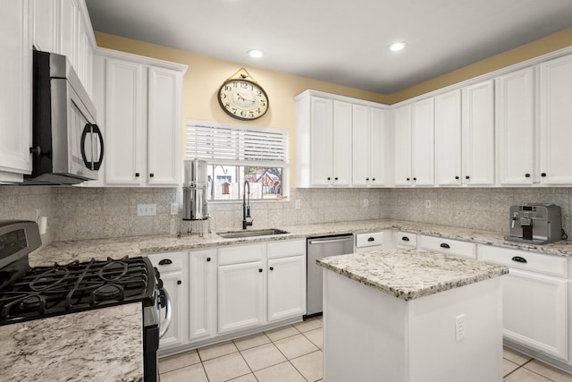 3233 Greenhead St, Katy, TX 77493 - kitchen featuring stainless steel appliances, a sink, white cabinetry, light tile patterned floors, and recessed lighting