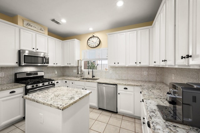 3233 Greenhead St, Katy, TX 77493 - kitchen with stainless steel appliances, a sink, light tile patterned floors, white cabinetry, and recessed lighting