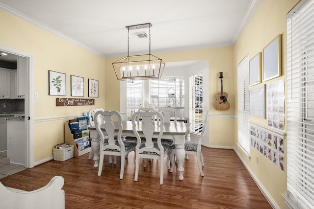 3233 Greenhead St, Katy, TX 77493 - dining space featuring ornamental molding, a chandelier, wood finished floors, and baseboards