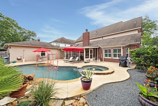 view of swimming pool featuring a sunroom, a patio area, fence, and a pool with connected hot tub