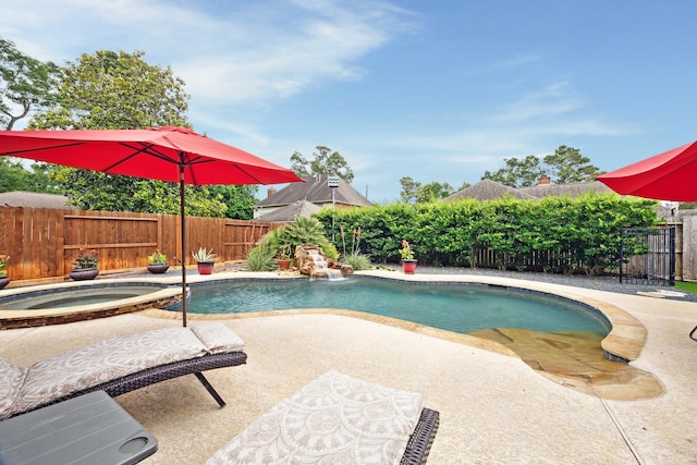 view of swimming pool featuring an in-ground hot tub, a patio, and a fenced backyard