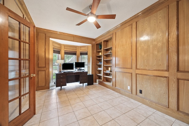office space with a ceiling fan, light tile patterned floors, and built in features