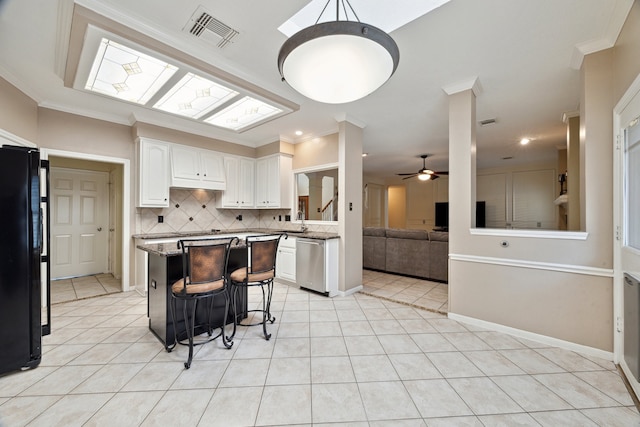 kitchen featuring freestanding refrigerator, dishwasher, white cabinets, a ceiling fan, and light tile patterned floors