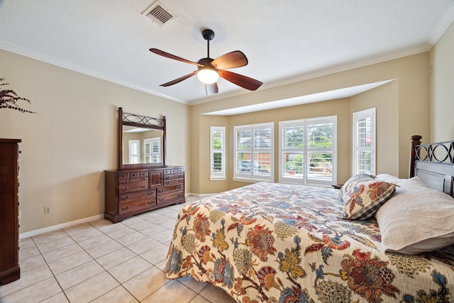 bedroom with multiple windows, ornamental molding, baseboards, light tile patterned flooring, and a ceiling fan