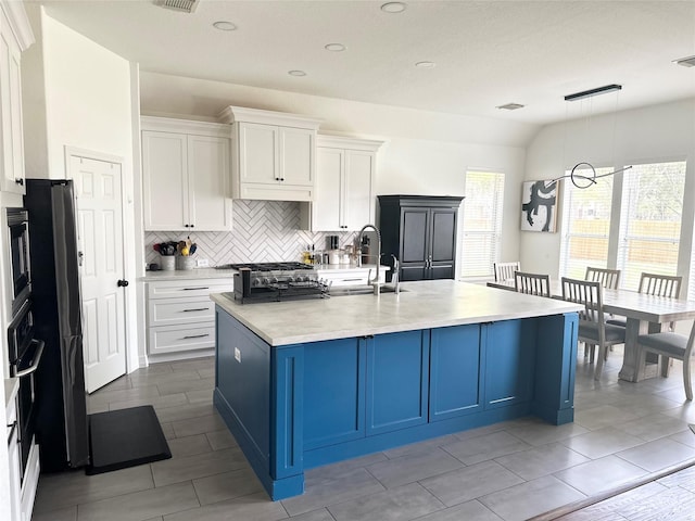 3522 Kent Knl, Missouri City, TX 77459 - kitchen featuring backsplash, light countertops, white cabinets, and a sink