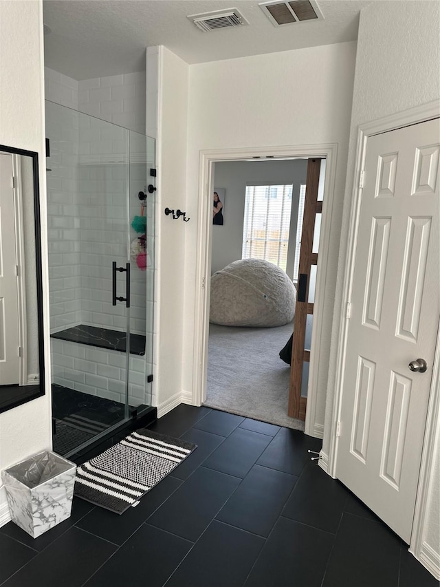 3522 Kent Knl, Missouri City, TX 77459 - bathroom with connected bathroom, a shower stall, baseboards, and tile patterned flooring
