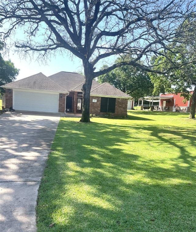 202 Golfview Dr, Normangee, TX 77871 - single story home with concrete driveway, a garage, brick siding, and a front yard