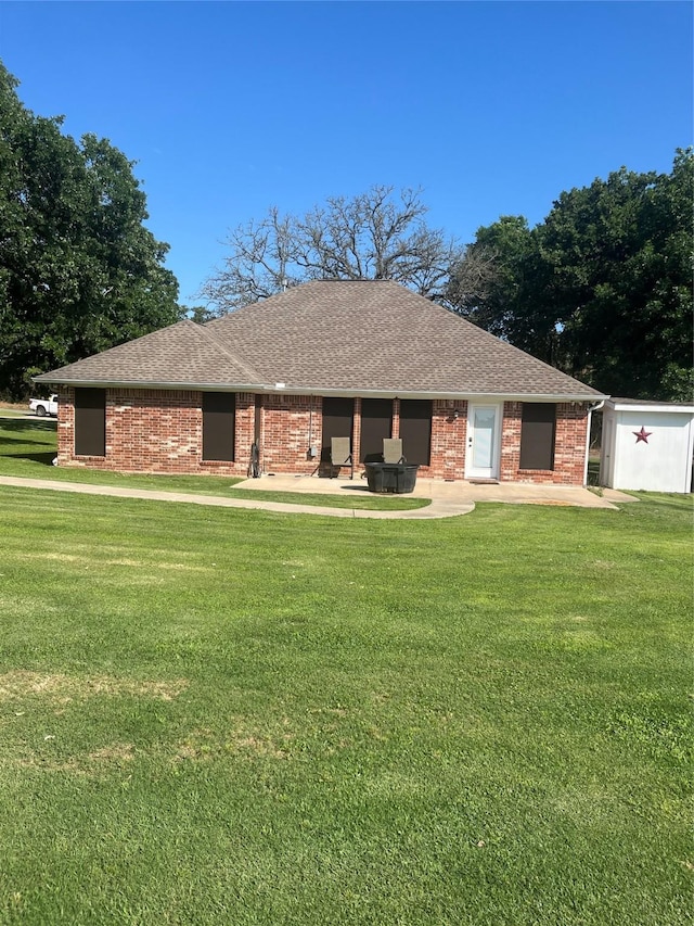 202 Golfview Dr, Normangee, TX 77871 - view of front of home featuring a front lawn, roof with shingles, and brick siding