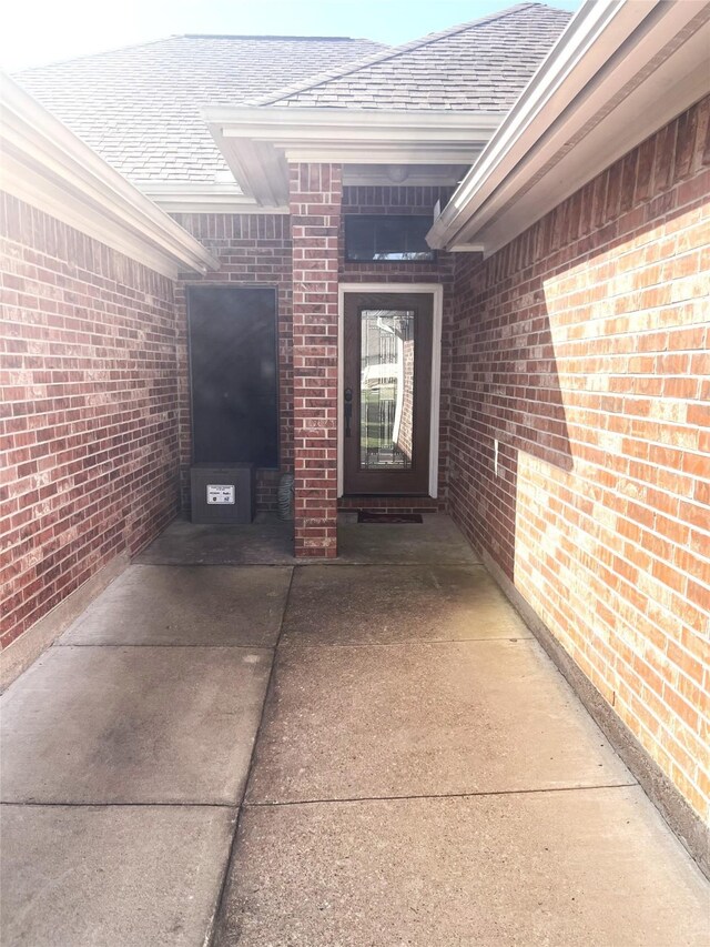 202 Golfview Dr, Normangee, TX 77871 - view of exterior entry with brick siding and a shingled roof