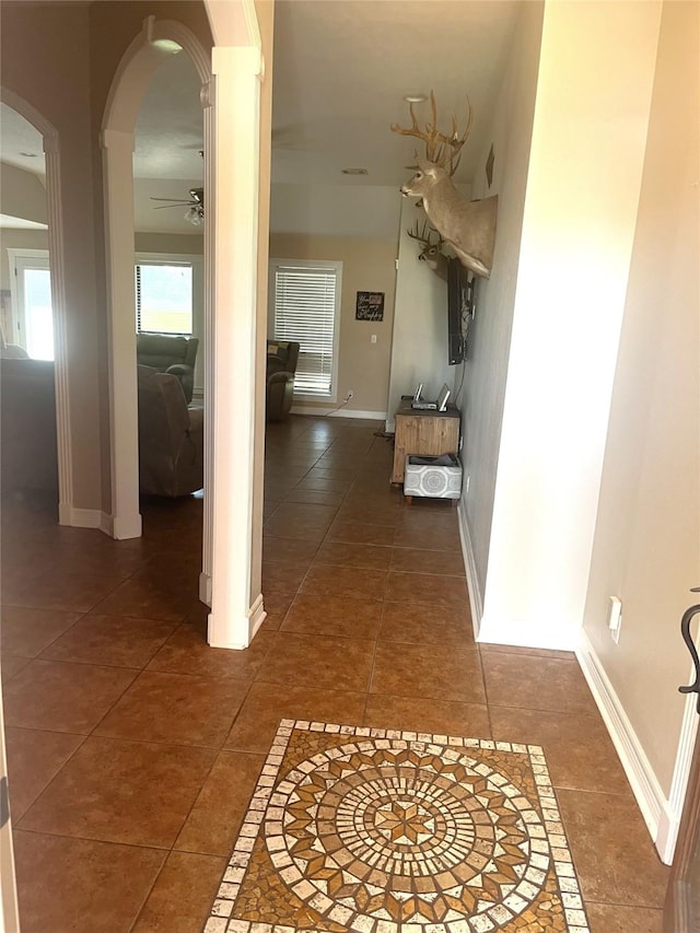 202 Golfview Dr, Normangee, TX 77871 - corridor with tile patterned flooring, arched walkways, and baseboards