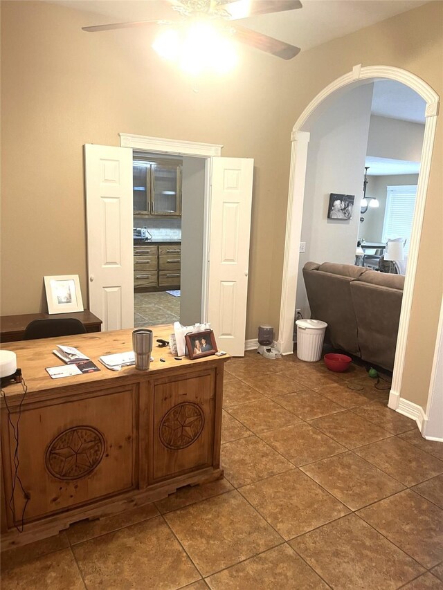 202 Golfview Dr, Normangee, TX 77871 - tiled office space featuring ceiling fan, arched walkways, and baseboards