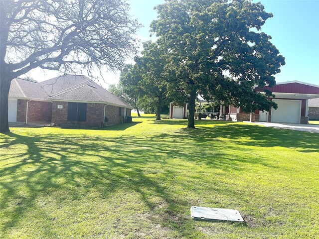 202 Golfview Dr, Normangee, TX 77871 - view of grassy yard with an attached garage