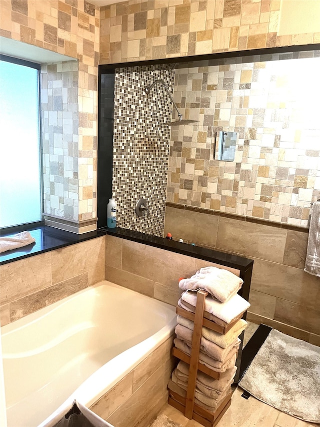 202 Golfview Dr, Normangee, TX 77871 - bathroom with tiled tub, tile walls, and tiled shower